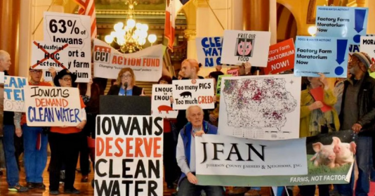 photo showing people holding signs about clean water at the Iowa captiol