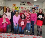 photo showing CCI members in the office posing for our Valentine's Day thank-a-thon